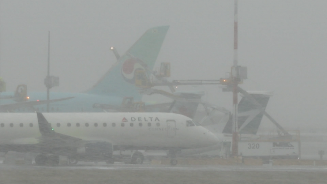 Planes are seen on the Vancouver International Airport tarmac during a snowstorm on Nov. 29, 2022. 