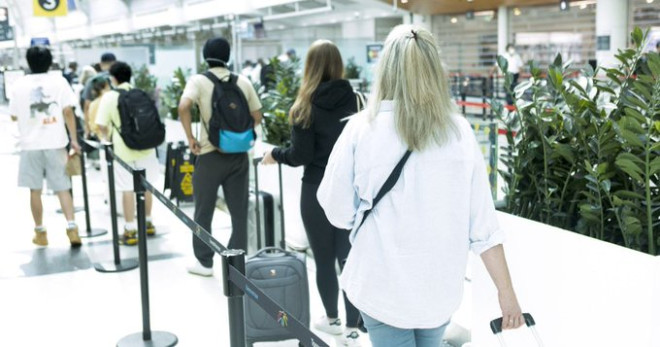 Passengers waiting in a security clearance line